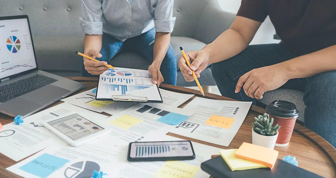 B2B marketing team reviewing account-based marketing strategy and charts together
