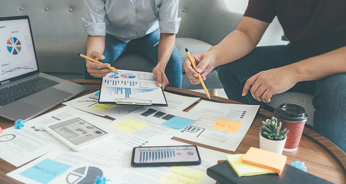 B2B marketing team reviewing account-based marketing strategy and charts together