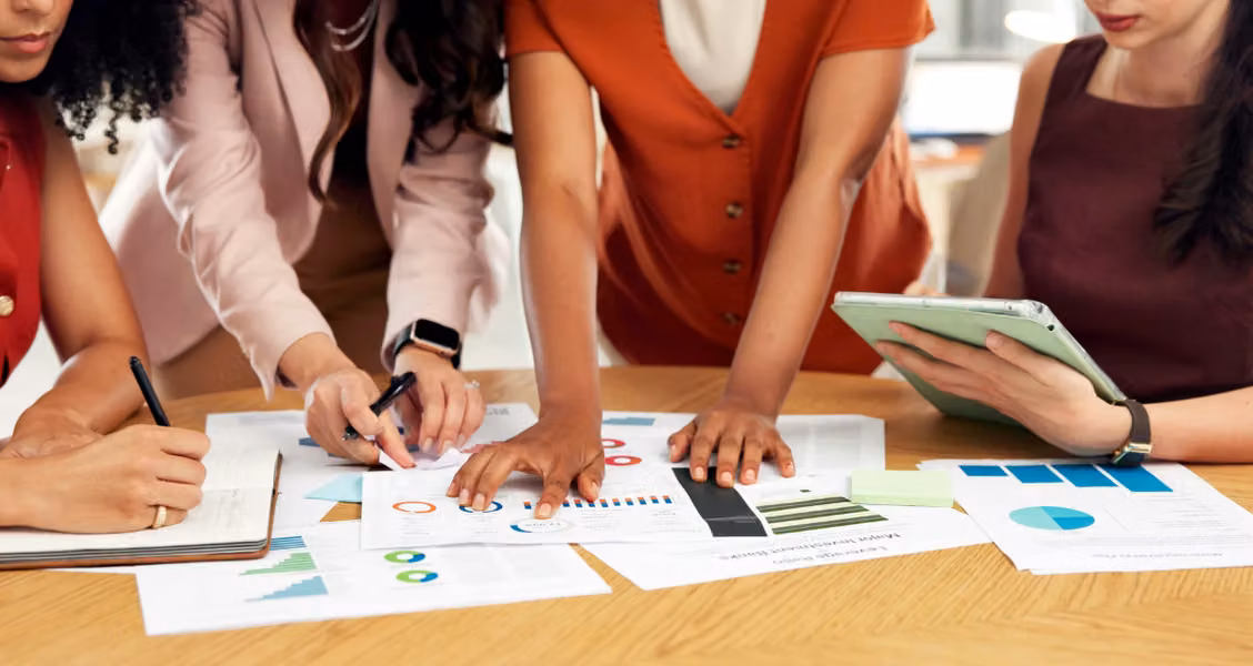 Marketing team reviewing campaign charts and data while planning a microsite