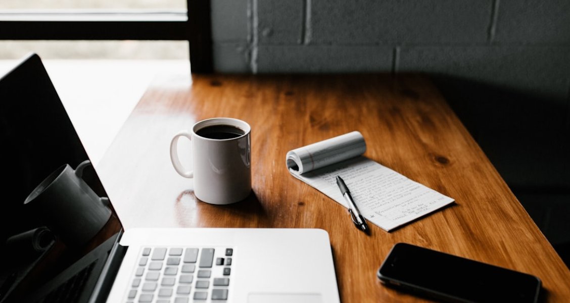Marketing professional writing a B2B case study on a laptop with a branded template on screen