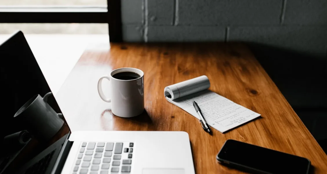 Marketing professional writing a B2B case study on a laptop with a branded template on screen