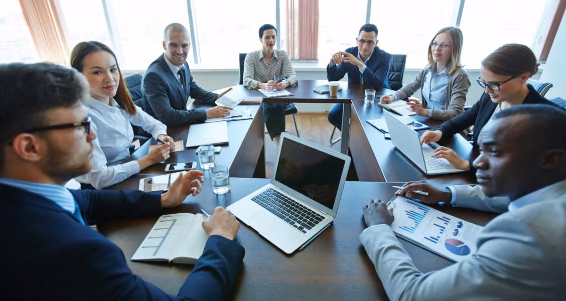Account team and client stakeholders in a kickoff meeting around a conference table