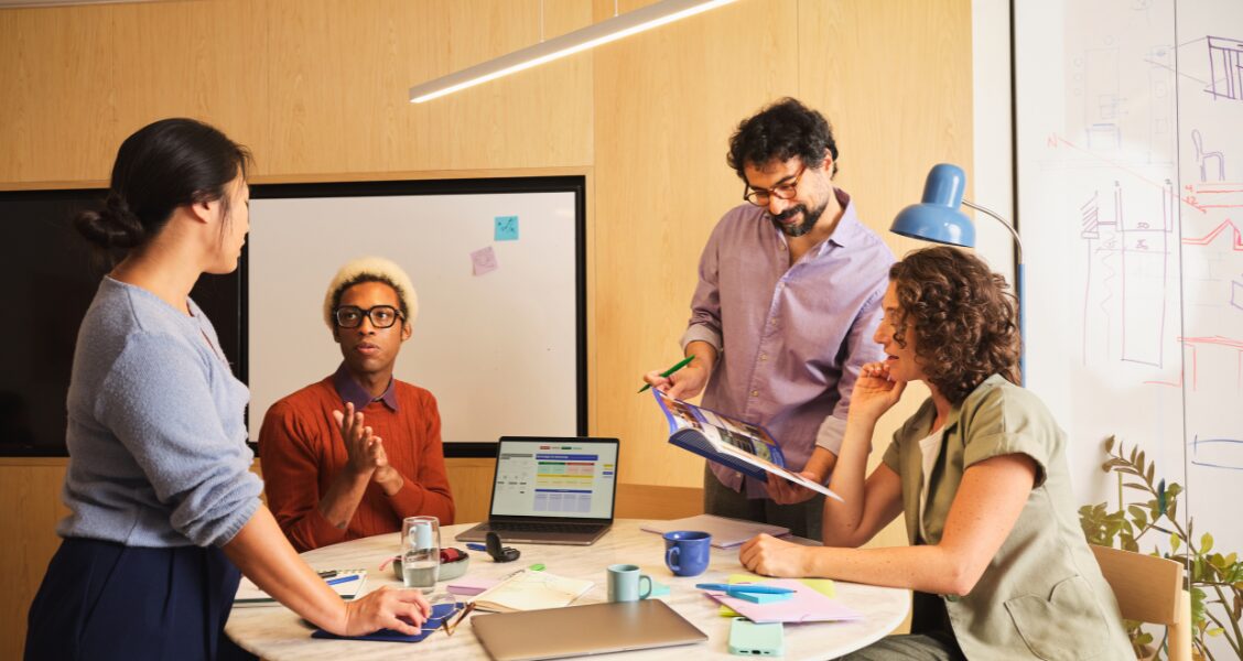 Stakeholders from marketing, legal, and brand reviewing a content approval workflow on screen