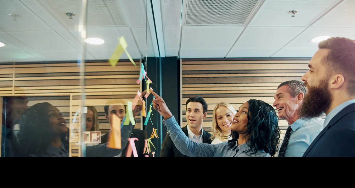 Enterprise sales team evaluating Highspot alternatives on a laptop in a conference room