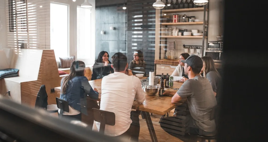 Business development team reviewing a competitive contract bid submission on a conference table