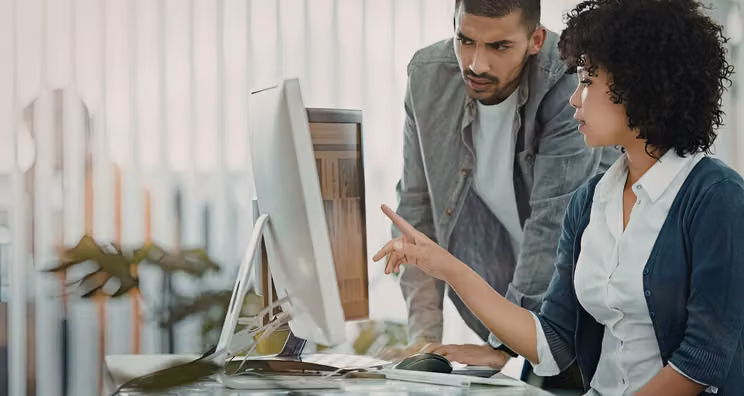 Marketing team comparing no-code microsite builder options on a laptop screen