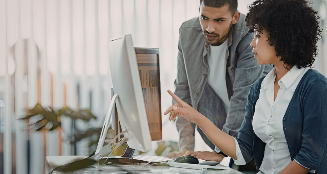 Marketing team comparing no-code microsite builder options on a laptop screen