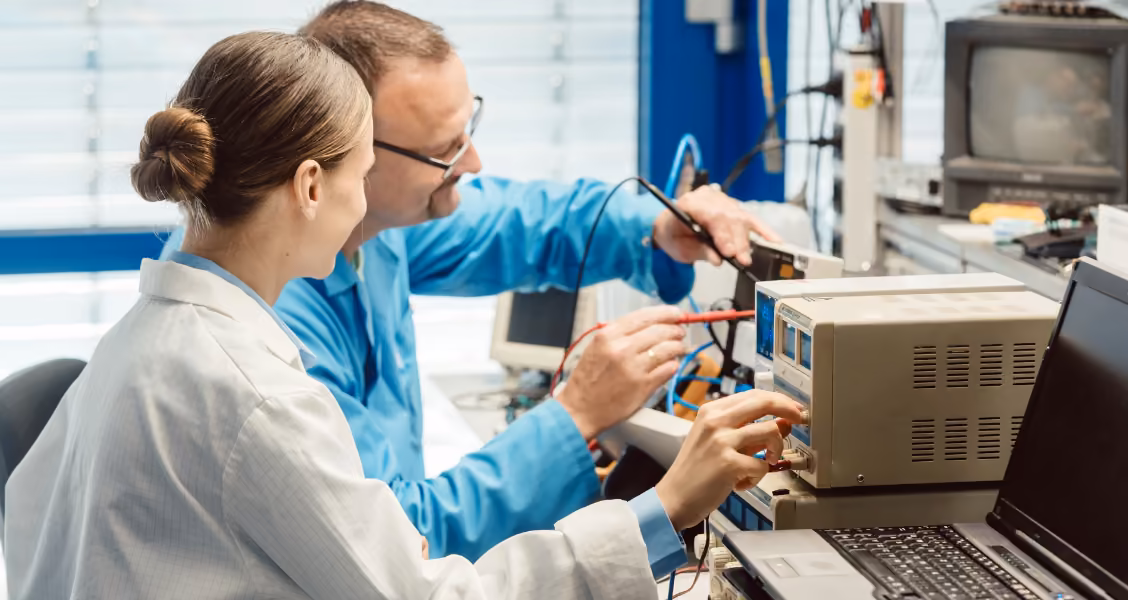 Two engineers test electronic equipment in a lab, gathering the specs a product datasheet reports