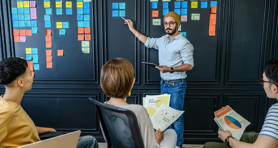 Editorial illustration of a professional customizing a proposal document at a desk, surrounded by abstract document panels