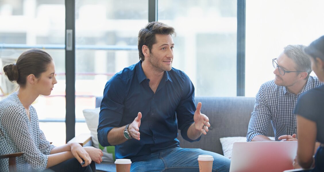 Sales rep delivering a pitch on a video call to a group of stakeholders