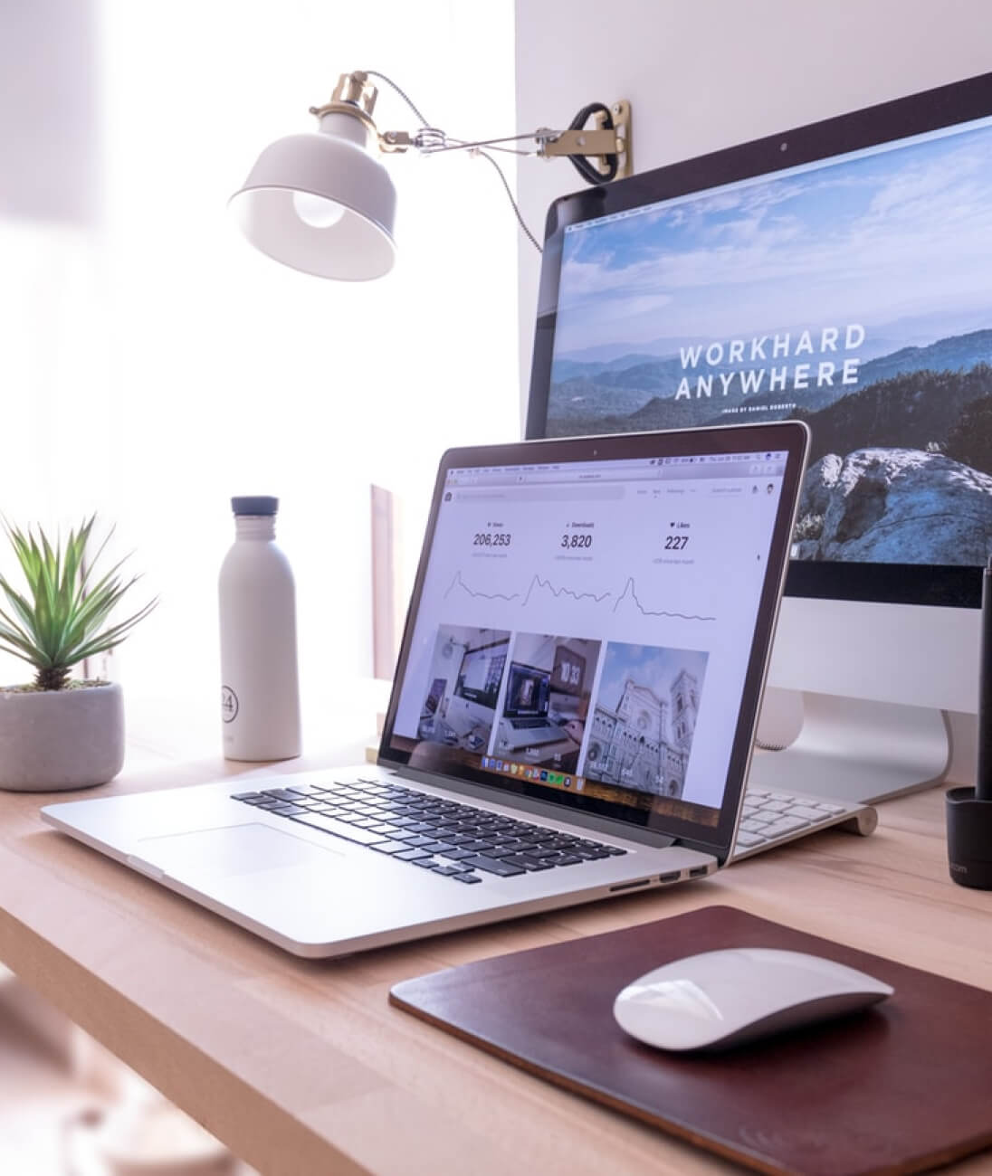 A desk with a laptop, a monitor, a keyboard and a computer mouse.