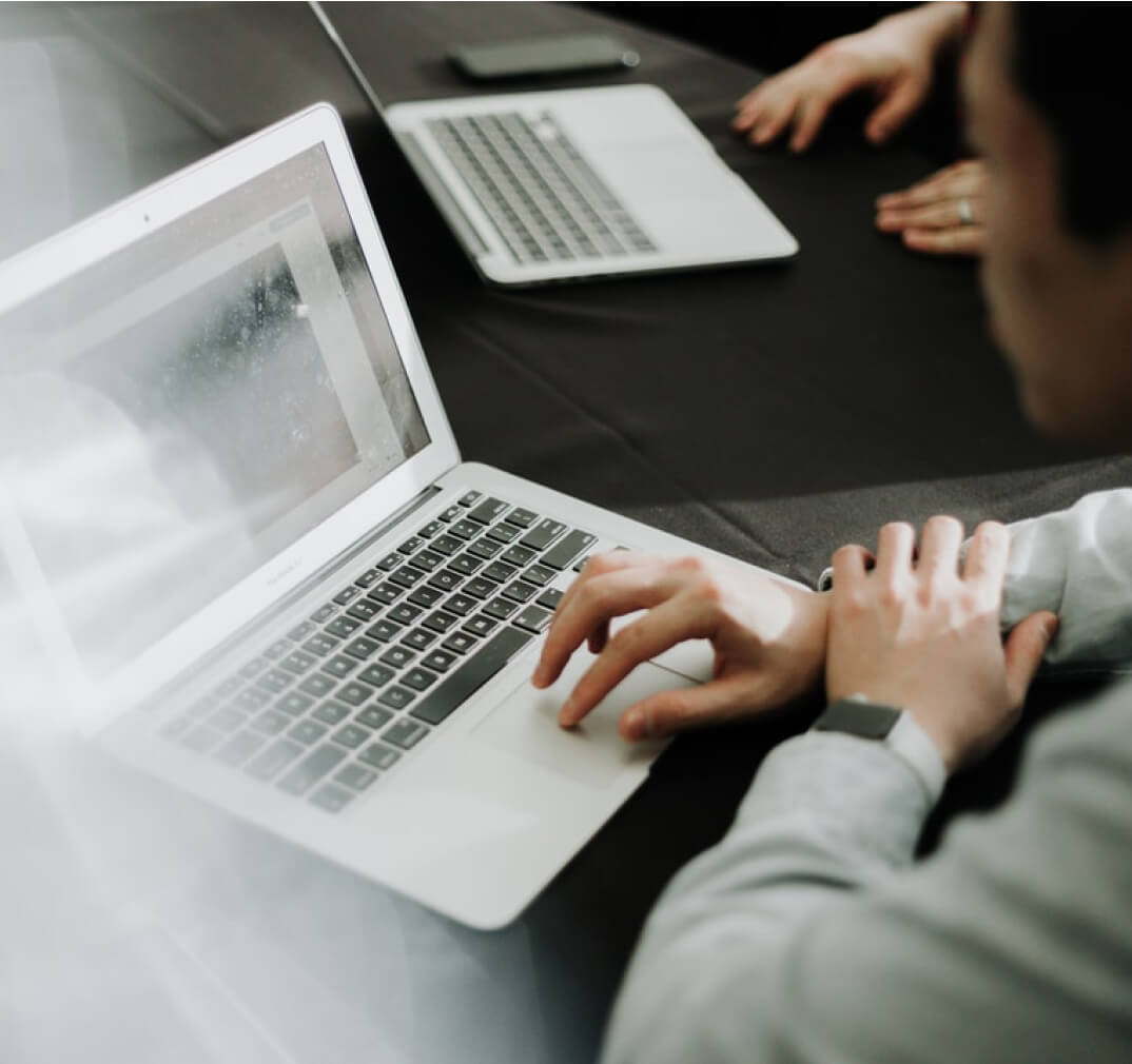 Two laptops on a desk.