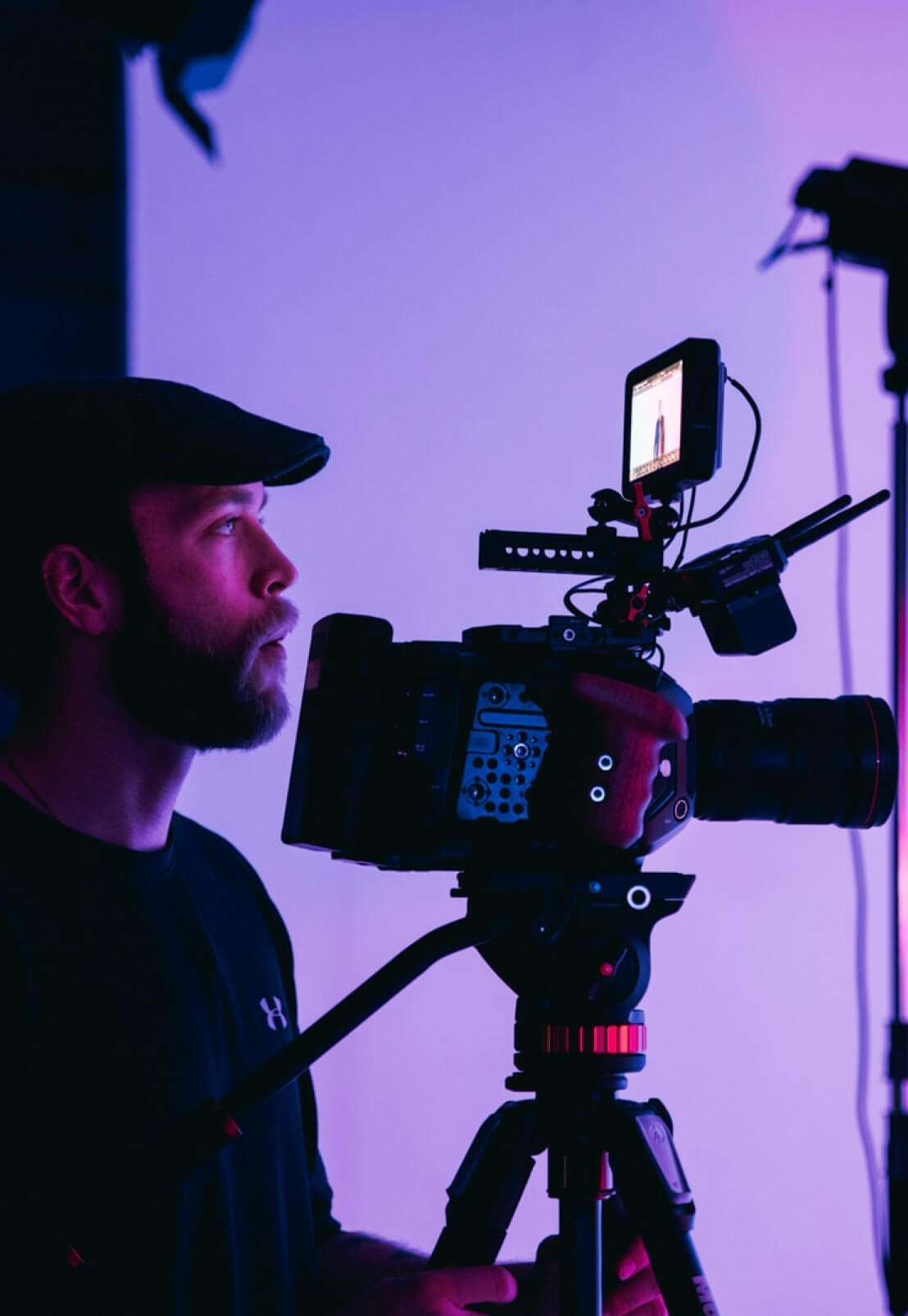 A man operating a digital video camera.