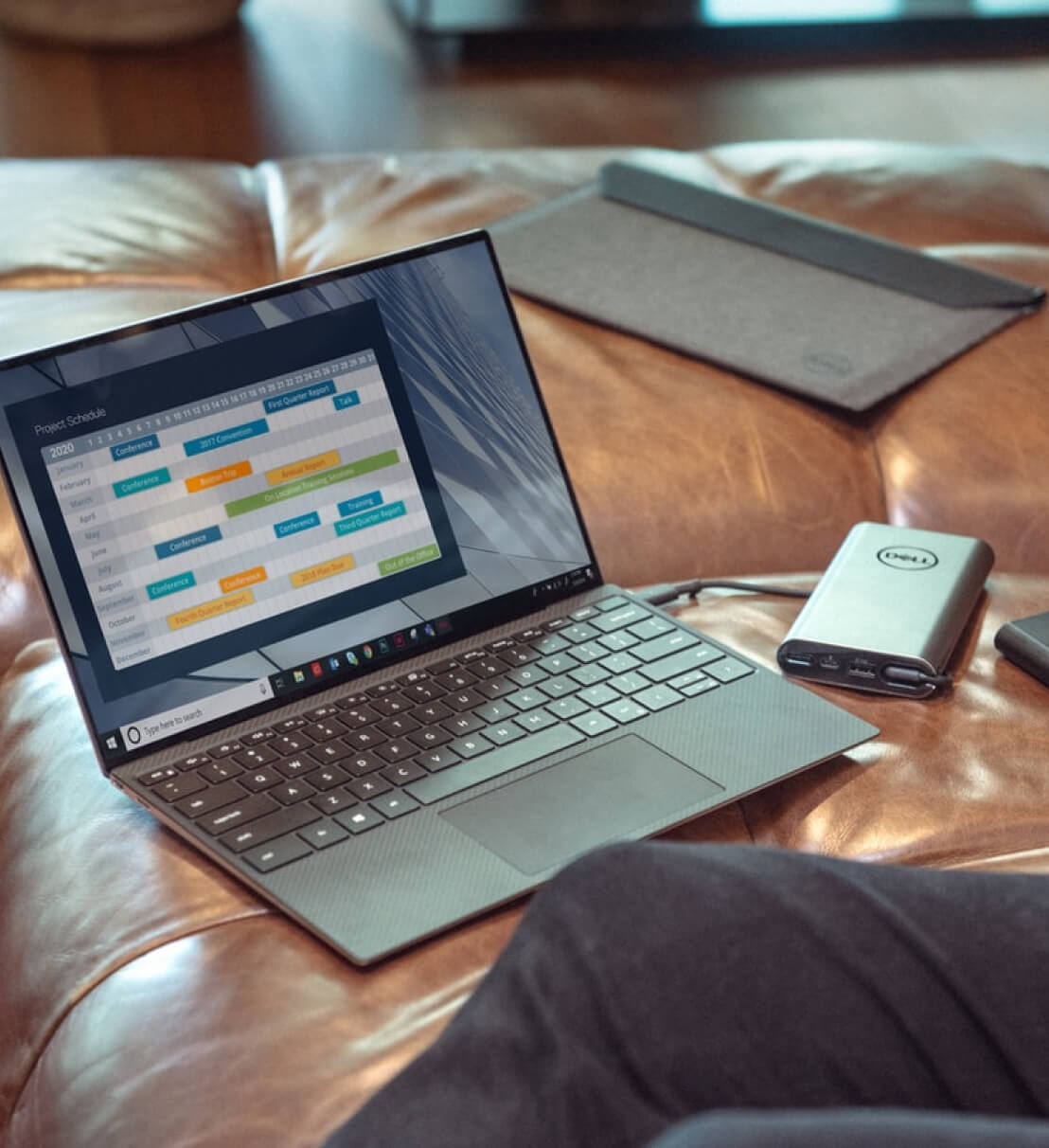 A laptop on a sofa.