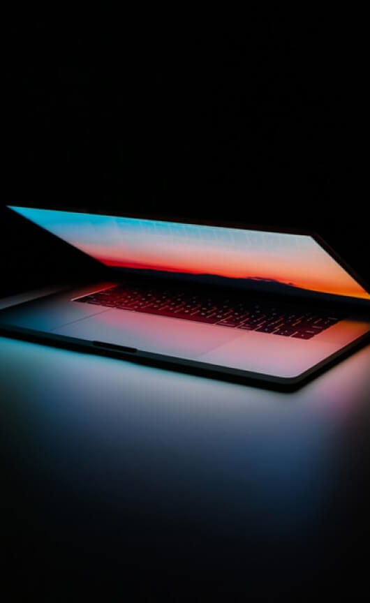 A laptop with the lid open halfway.