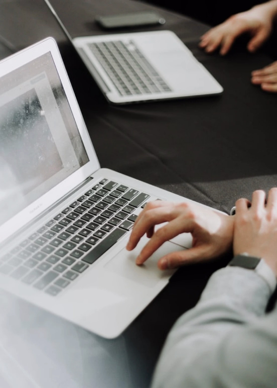 Two laptops being used on a desk