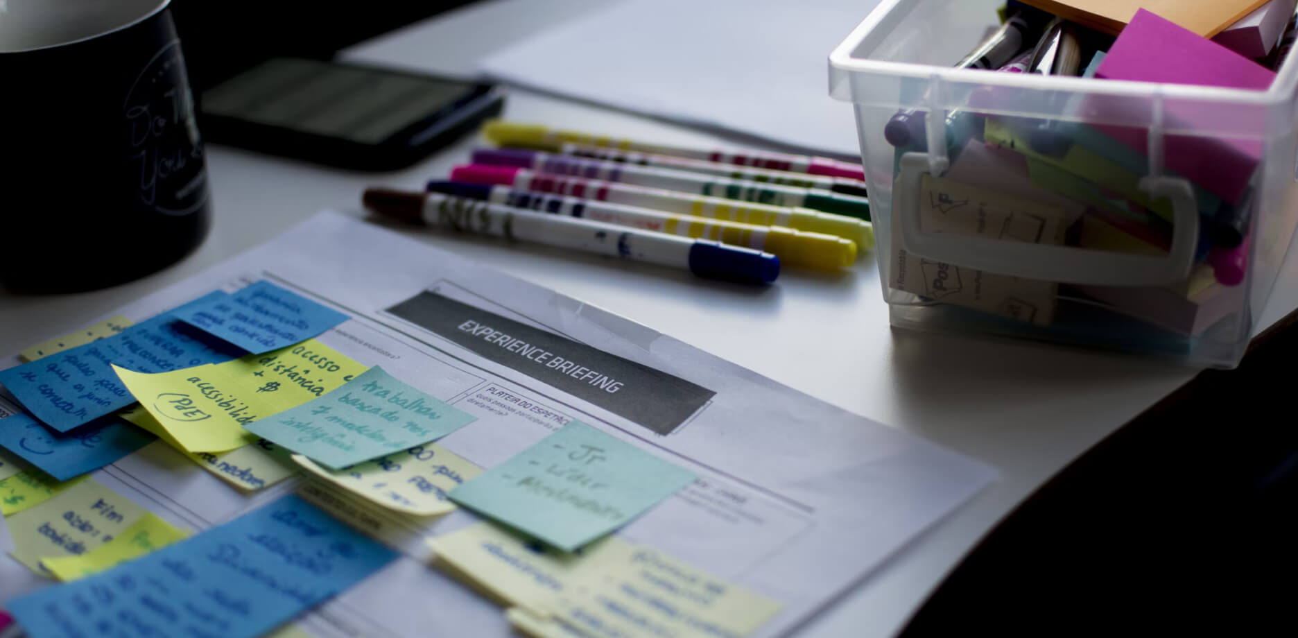 Printed design brief with post-it notes attached.